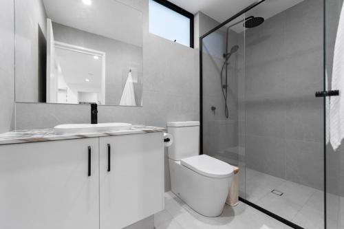 a bathroom with a toilet and a sink and a shower at Mangini Apartments - Unit 1 in Perth