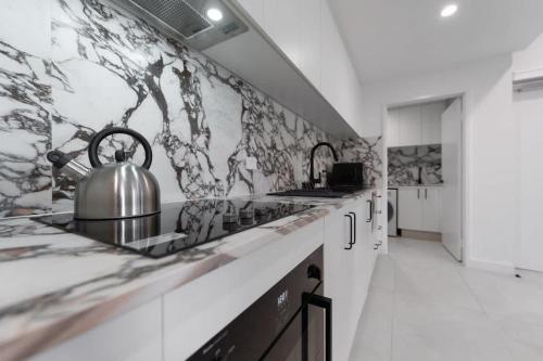 a kitchen with a tea kettle on the counter at Mangini Apartments - Unit 1 in Perth