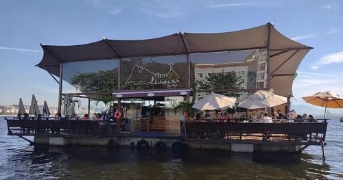 a restaurant on a pier in the water at Studio na Urca in Rio de Janeiro