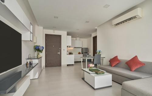 a living room with a couch and a television at Noden Hotel & Apartment in Phnom Penh
