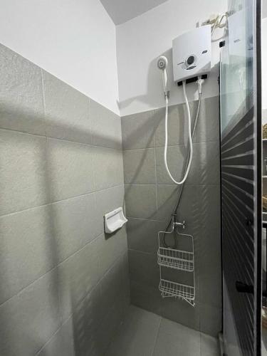 a bathroom with a shower with a shower head at Solea Tropical Suite in Davao City