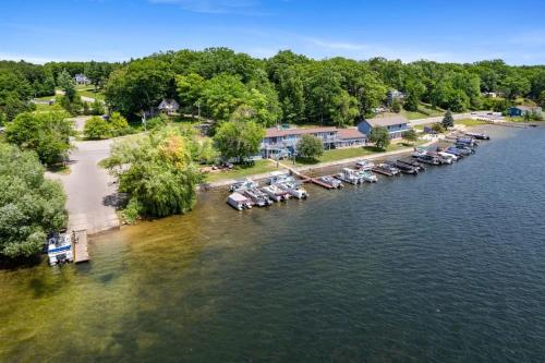 an aerial view of a group of boats in the water at Group Getaway - 5 Lodges Together by Fife Lake in Fife Lake