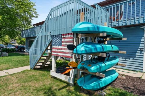 a slide in front of a house with an american flag at Group Stay - 3 Lodges Together by Fife Lake in Fife Lake