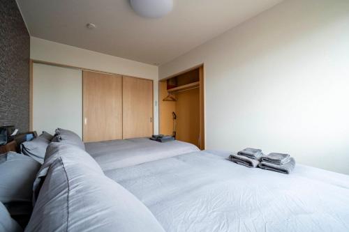 a bedroom with two beds with towels on them at Lambent in Kami-furano