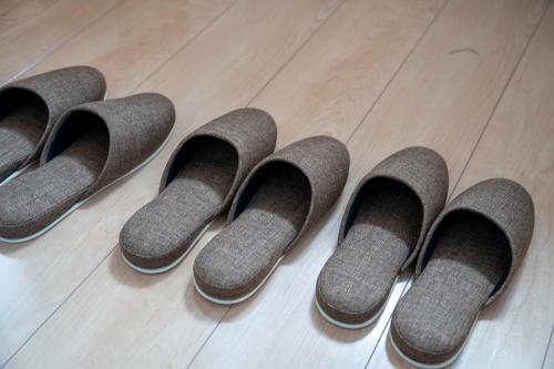 a group of four pairs of shoes on a wooden floor at Lambent in Kami-furano