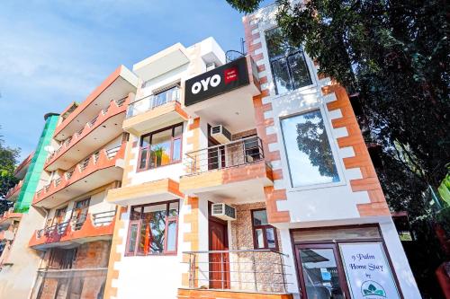 a building with a sign on the side of it at Hotel O 9 Palm in Rājpur