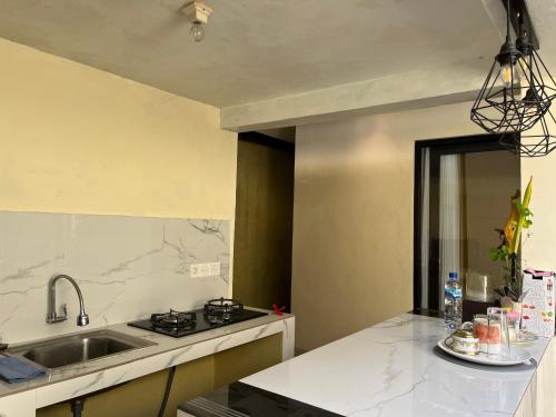 a kitchen with a sink and a counter top at Oemah Dharma Garden View by EPS in Gianyar