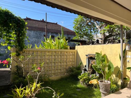a fence in the yard of a house at Oemah Dharma Garden View by EPS in Gianyar