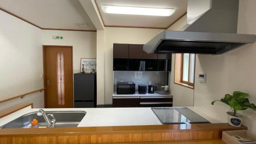 a kitchen with a sink and a stove at POLARiS in Tateyama