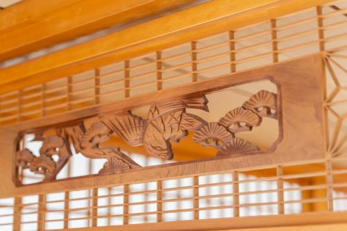 a wooden stairwell in a room with a window at O-KiNAWA HOUSE in Onna