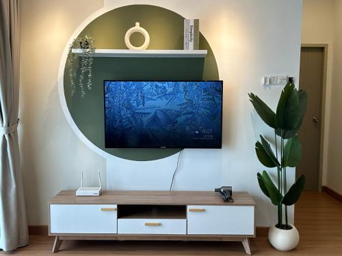 a living room with a tv on a wall at Youth City Residences by Manhattan Group in Nilai