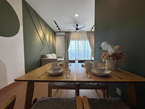 a dining room table with cups and saucers on it at Youth City Residences by Manhattan Group in Nilai
