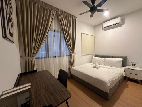 a bedroom with a bed and a table and a ceiling fan at Youth City Residences by Manhattan Group in Nilai