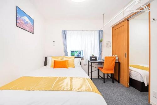 a bedroom with a bed and a desk with a computer at Akihabara Skytree Premium Apartment 302 in Tokyo