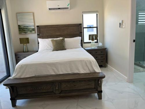 a bedroom with a large bed and a window at Drift & Discovery New Modern Stay, Mins to Beach! in Brissett Run