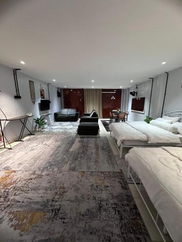 a large room with two beds and a couch at MAMAB SMART HOME STUDIO HOMESTAY - Tepi Highway Melor in Kota Bharu