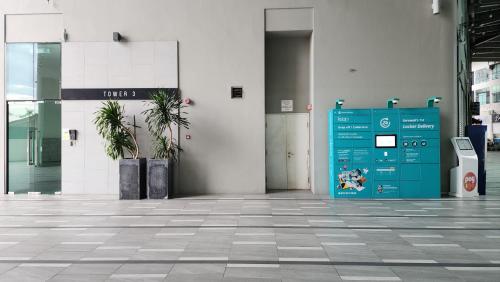 a lobby with a blue door in a building at Luxe Loft 3BR Emporium 9pax in Kuching
