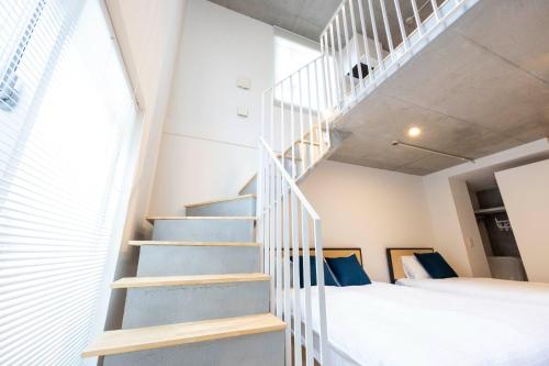 a staircase leading up to a bedroom in a tiny house at PASEO Ichigayadaimachi 2 in Tokyo