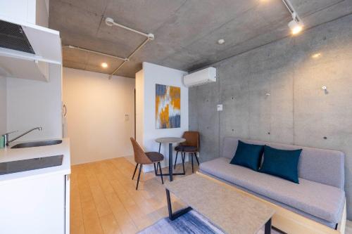 a living room with a couch and a table at PASEO Ichigayadaimachi 2 in Tokyo