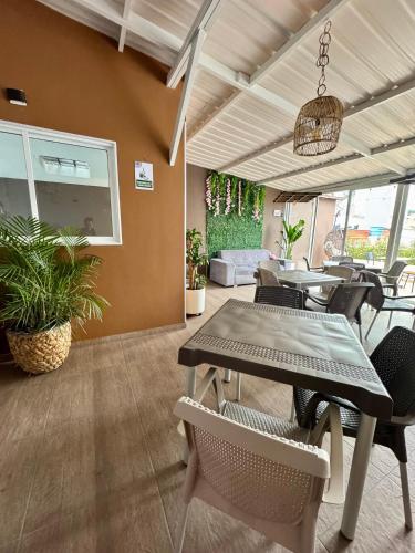 a dining room with a table and chairs at HOTEL JARDIN 38 in Pasto