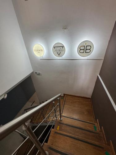a set of stairs with three signs on the wall at HOTEL JARDIN 38 in Pasto