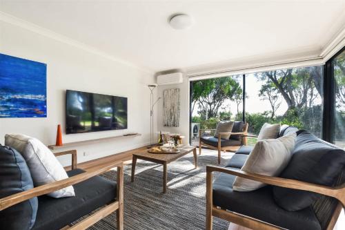 a living room with two couches and a large window at 2 CapeView Beachfront Geographe Bay in Broadwater
