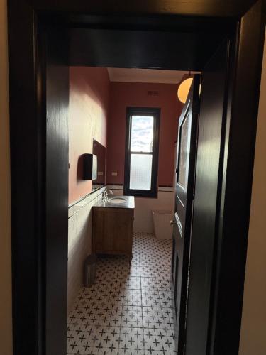 a bathroom with a sink and a window at Royal Oak Hotel in Ballarat