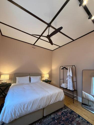 a bedroom with a white bed and a ceiling at Royal Oak Hotel in Ballarat
