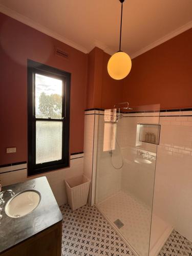 a bathroom with a shower and a sink at Royal Oak Hotel in Ballarat