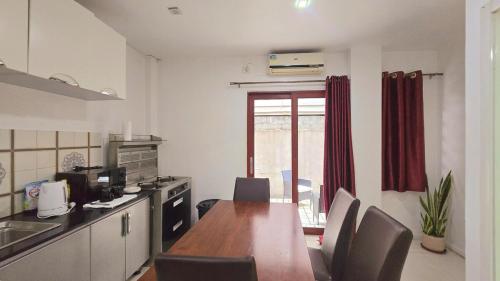 a kitchen with a wooden table and chairs in it at CBD Entire Apartment 102 in Suva
