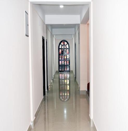 a hallway of a building with a stained glass window at Nigaah Homestay By StayApart in Mirik