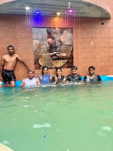 a group of people in a swimming pool at Greenspun Nature stay in Somvārpet