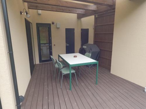 a table and chairs sitting on a deck at 伊勢志摩パールヴィレッジ ヴィラ in Shima