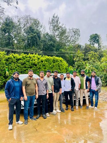 a group of men standing in front of a truck at Greenspun Nature stay in Somvārpet