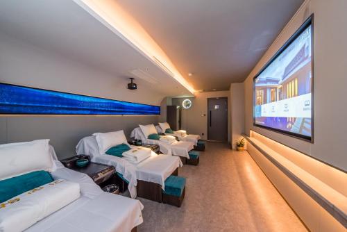 a hospital room with beds and a large screen at Grand Sun City Hotel-Located city center Metro Access in Changsha