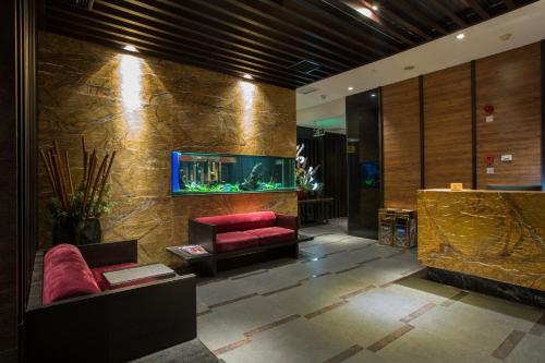a lobby with a fish tank on the wall at Grand Sun City Hotel-Located city center Metro Access in Changsha