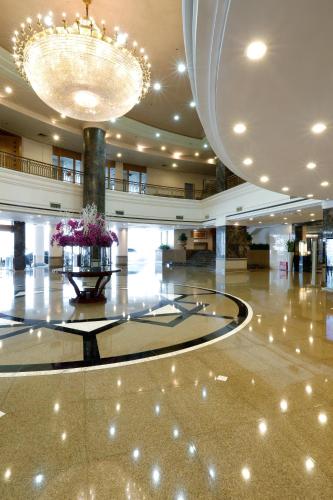 a large lobby with a large chandelier and a large room at Grand Sun City Hotel-Located city center Metro Access in Changsha