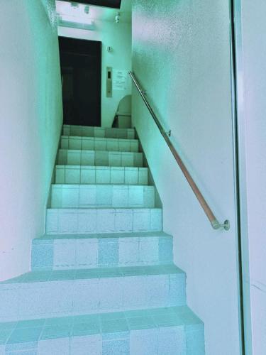a staircase in a building with blue and white tiles at Sun Hotel in Tokyo