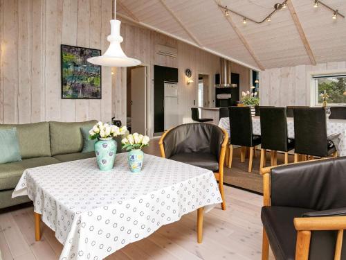 ティステズにある6 person holiday home in Thistedのダイニングルーム(花のテーブル付)