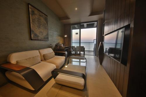 a living room with a couch and a table at Pledge Scape in Negombo
