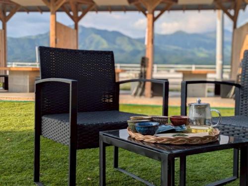 a table and chairs with a tray of food on it at 南阿蘇サウナ5gaku G4 in Minami Aso