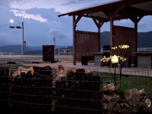a fence in front of a building with rocks at 南阿蘇サウナ5gaku G5 in Minami Aso