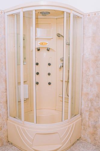 a shower in a bathroom with a glass enclosure at Villa Di Angelo Negombo in Negombo