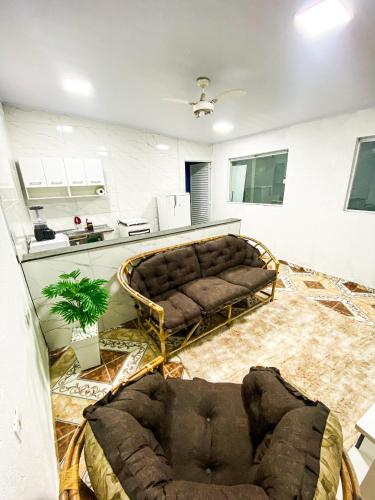 a living room with a couch in the middle at Casa a 400m do Mar - O endereço correto é o Rua Rubens Marcus Rocha 541 Jd Jamaica Itanhaem in Itanhaém