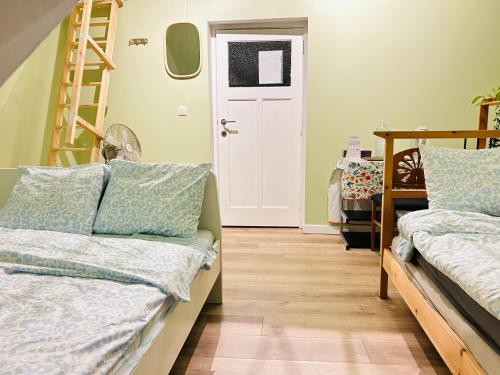 a room with two beds and a white door at Family-friendly room in Kessel-lo, Leuven,Belgium in Leuven