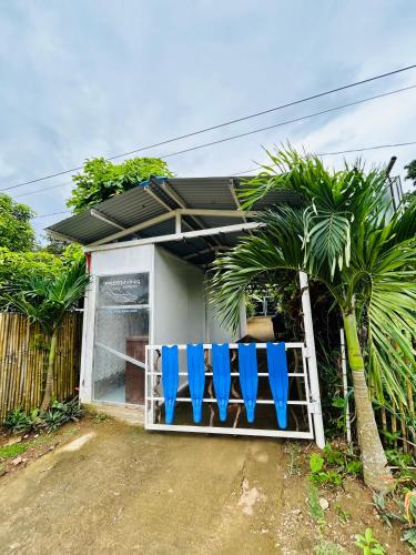 a group of blue chairs sitting in front of a house at Barracuda Swim Club's Homestay - Aircon Room with Pool in Coron