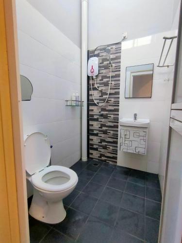 a bathroom with a toilet and a sink at The 3's Homestay Alor Setar #FREE UNIFI in Alor Setar