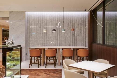 a dining room with a table and chairs at Hotel Hyundai by Lahan Ulsan in Ulsan