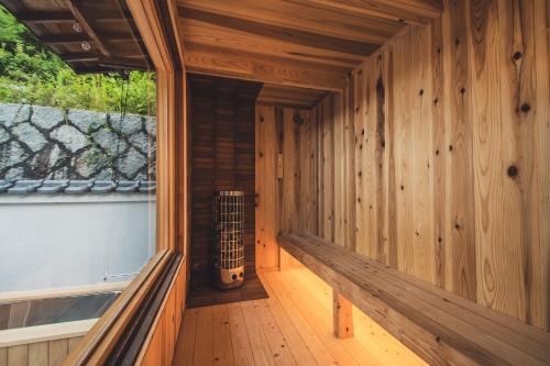 an inside view of a wooden room with a guitar at サウナとアートの宿 瀬戸内一棟貸切 Sei-Jima Retreat in Sakaide