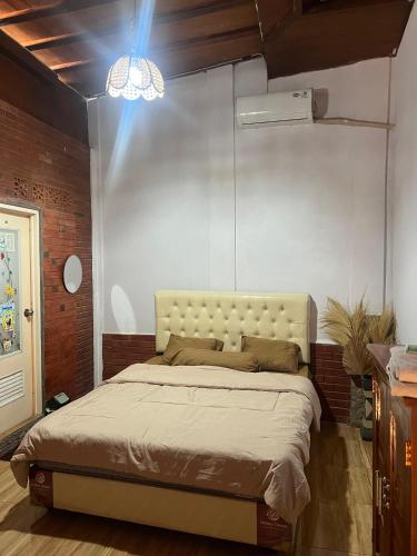 a bedroom with a bed in a room at Homestay Omah Joglo in Gading